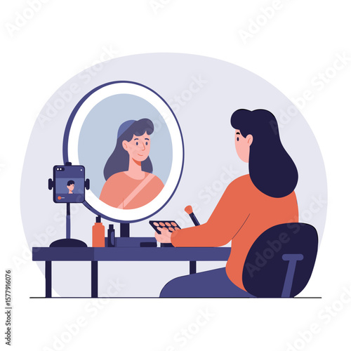 Woman applying makeup in front of a mirror with a ring light and recording a video on her phone on a desk