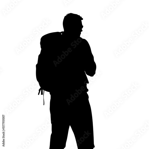 Silhouette of a traveler with backpack standing in profile  