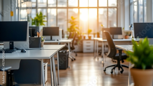 Wallpaper Mural Empty modern office with computers and plants near large window during sunrise. Torontodigital.ca