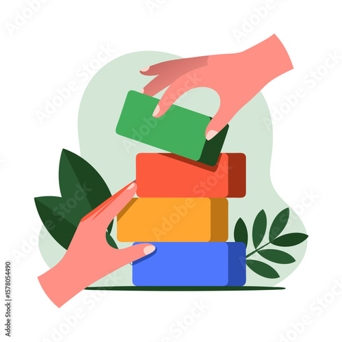 Two hands collaboratively build a colorful stack of blocks, symbolizing teamwork and cooperation.