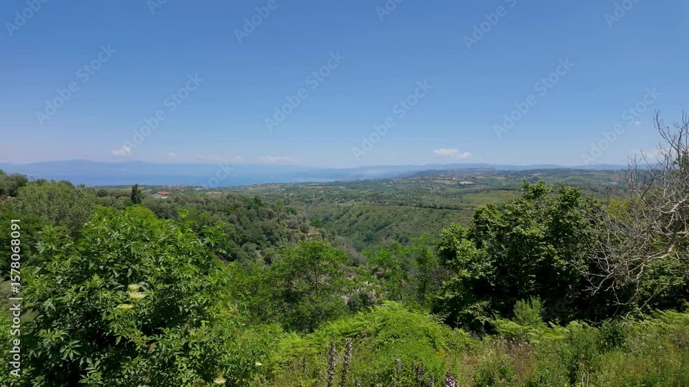 Breathtaking panorama from Zungri, Calabria, showcasing the Tyrrhenian Sea, verdant hills, and a serene blue sky Breathtaking panorama from Zungri, Calabria, showcasing the Tyrrhenian Sea, verdant hills, and a serene blue sky