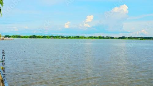 Phayao Series : Timelapse shot of Kwan Phayao Lake and the intricate mountain view in bright weather. Important natural tourist attractions in Phayao Province. Panorama of Lake. 