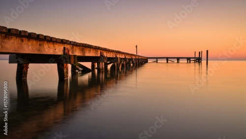 Wallpaper Mural Serene Wooden Pier Reflects Golden Sunset Over Calm Water Torontodigital.ca
