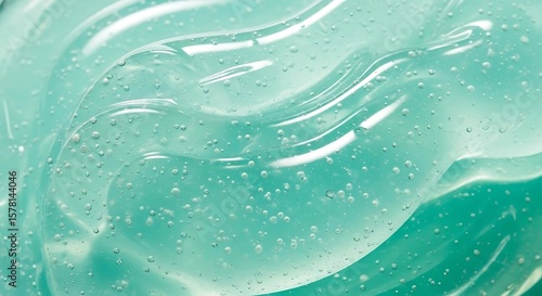 Close-up view of a translucent, gel-like substance with bubbles, showing texture.