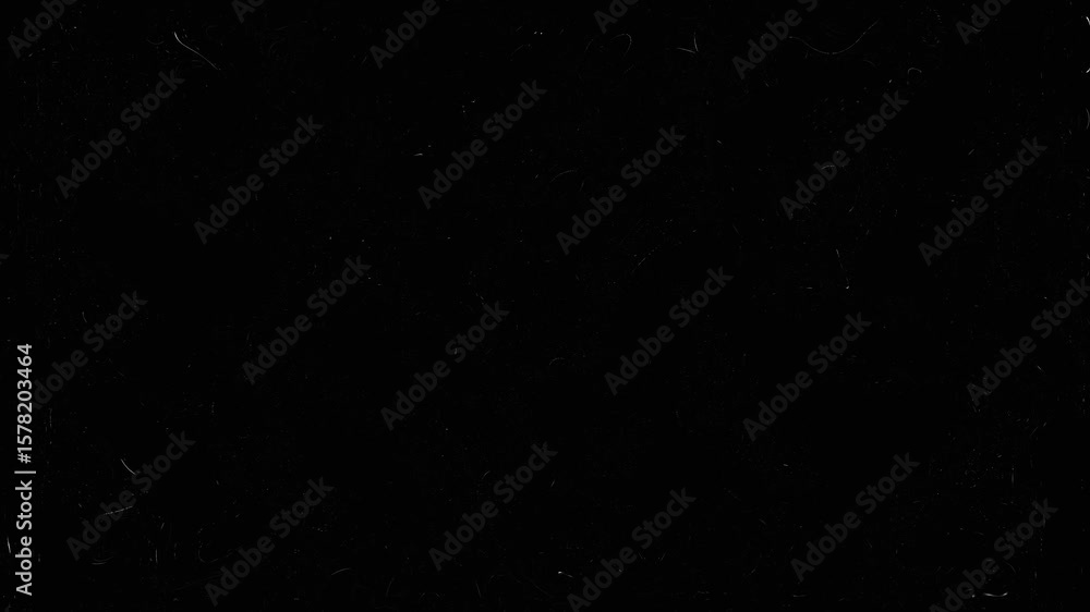 dust and grain on old damaged filmstrip surface. Dusty grunge rough vintage video on black background. Retro vintage film effect. Old movie fx film strip motion footage overlay on black background.