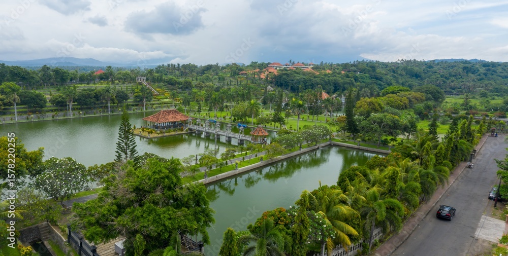 Fototapeta premium Aerial view of Taman Ujung Water Palace, a former royal palace, now a tourist attraction, featuring ponds, gardens, and ornate structures in Ujung, Bali, Indonesia