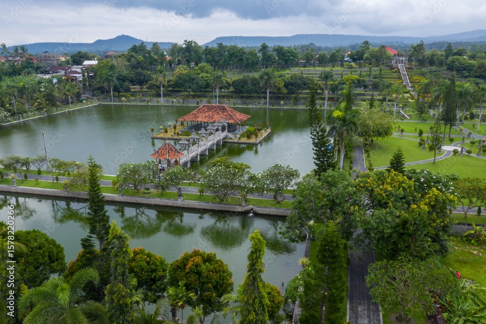 Fototapeta premium Aerial view of Taman Ujung Water Palace, a former royal palace, now a tourist attraction, featuring ponds, gardens, and ornate structures in Ujung, Bali, Indonesia