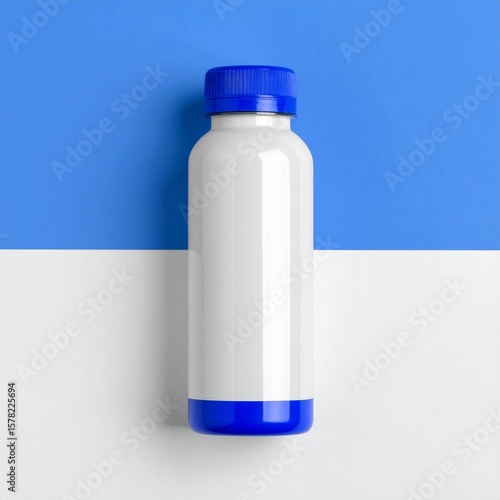 Minimalist Product Mockup: White Bottle with Blue Cap on Bicolor Background