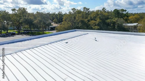 White roof coating protecting commercial building from sunlight
