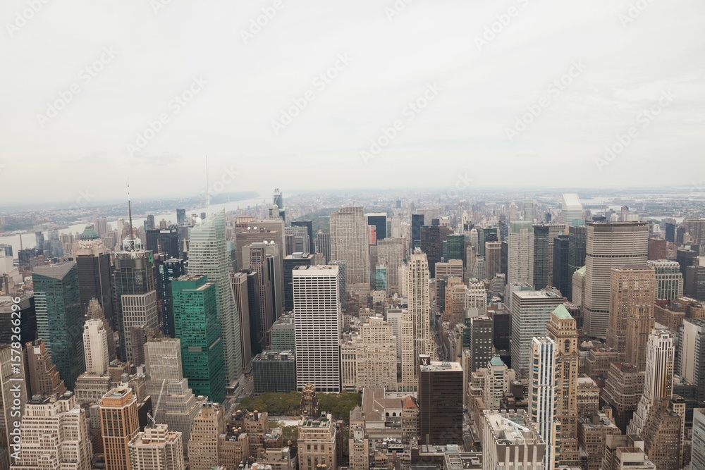 Fototapeta premium Flat design urban skyline is featuring glass skyscrapers, rooftop water tanks under overcast sky