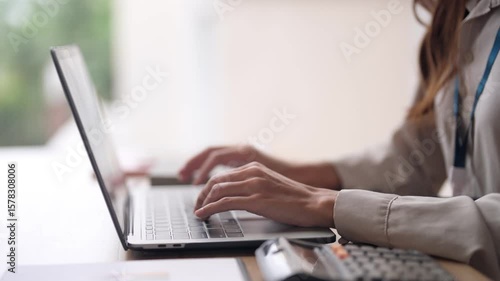 Confident Asian businesswoman hands typing laptop keyboard work analyze data create business report productive office environment