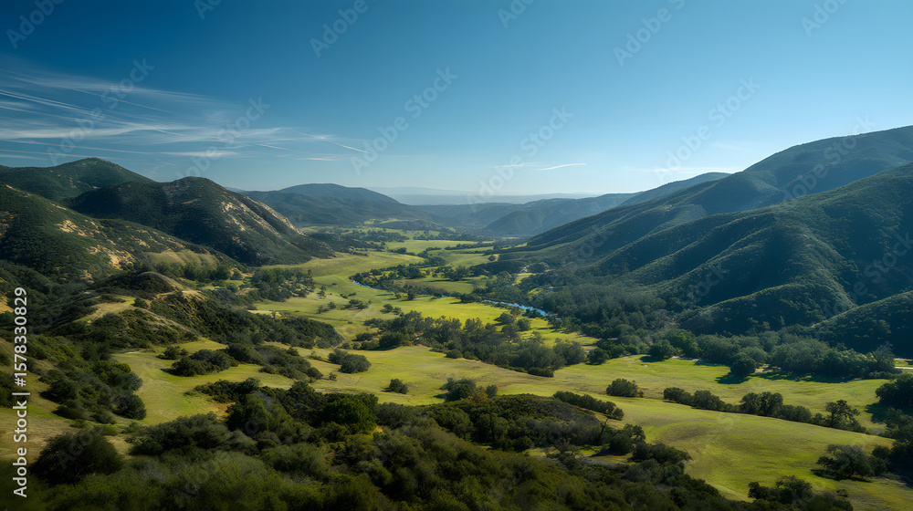 Fototapeta premium Serene Verdant Valley with Winding River and Rolling Hills Under a Clear Blue Sky