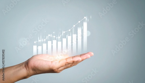 A line graph showing real-time stock price trends floating above a hand on a blurred grey background