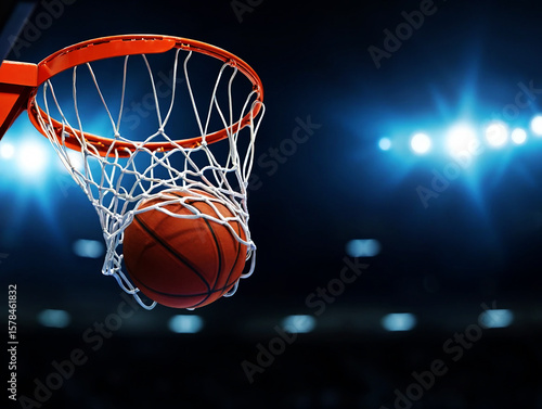 Basketball hoop with ball in net under stadium lights sport