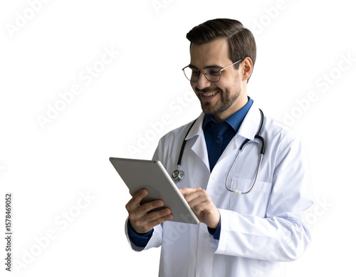 transparent background Happy young Caucasian doctor man in stylish eyeglasses and white coat typing on digital gadget, using tablet fir online medical communication, chatting with patients, looking aw