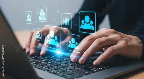 Hands typing on laptop with hr icons