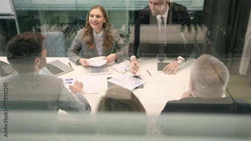 Business office with people casual wear, with blurred bokeh background, view from glass wall