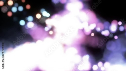 Abstract bokeh background with bright light and colorful particles floating in space