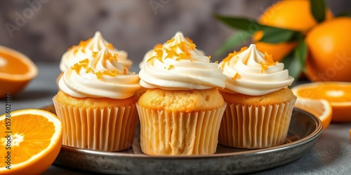 Fluffy homemade sweet orange cupcakes with vibrant orange zest topping,  orange,  eggs