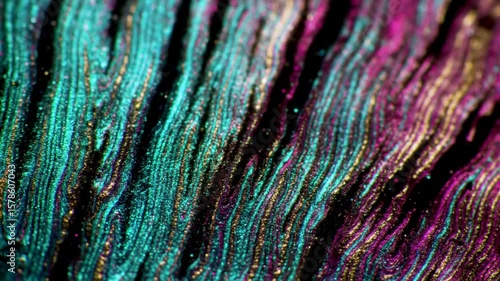 Abstract flowing particle background animation in teal, pink, and gold colors