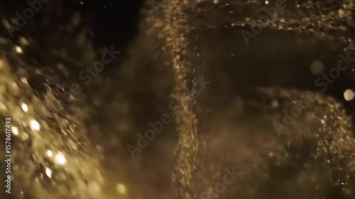 Abstract golden particles swirling in a slow motion with bokeh effect background