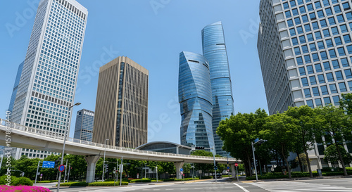 Contemporary Cityscape: Glass Skyscrapers, Blue Sky, and Urban Greenery