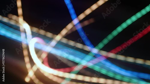 Abstract Light Trails of Various Colors Moving Against a Black Background