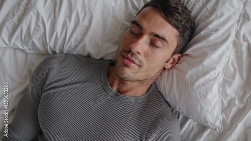 Attractive man peacefully sleeping in cozy bed
