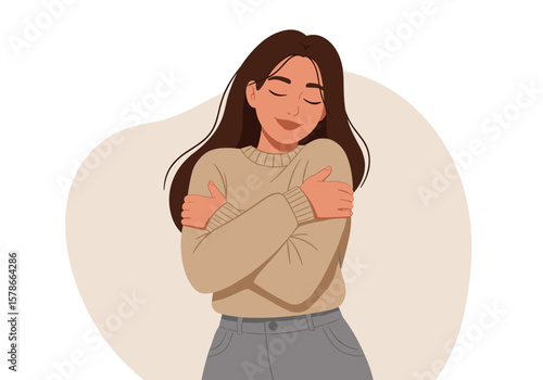 A young woman with long brown hair stands embracing herself, showing self-love and contentment against a soft, neutral background, radiating positivity.