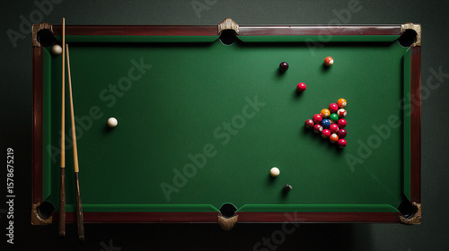 billiard table with balls and cue