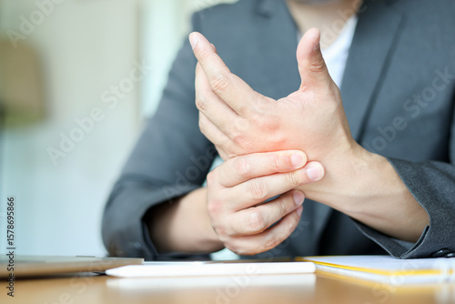 Fotografie close up employee man massage on his hand and arm for relief pain from hard work