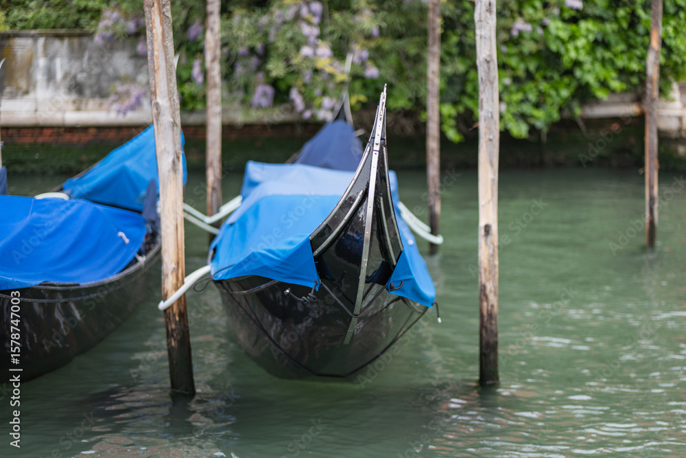 Quiet morning in Venice with gondolas waiting on the serene canal waters Quiet morning in Venice with gondolas waiting on the serene canal waters
