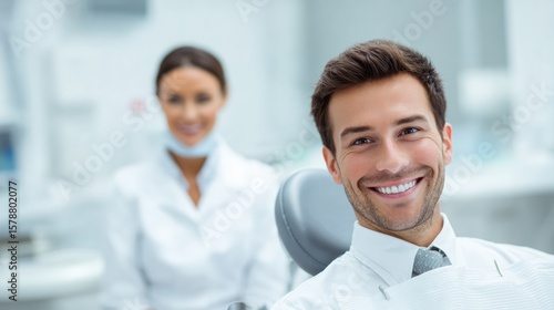 Wallpaper Mural Smiling man in a dental chair with a dentist in the background, showcasing a positive dental experience in a modern clinic. Torontodigital.ca
