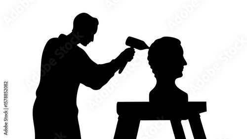 Silhouette of a sculptor working on a bust with a hammer and chisel in a studio environment shown