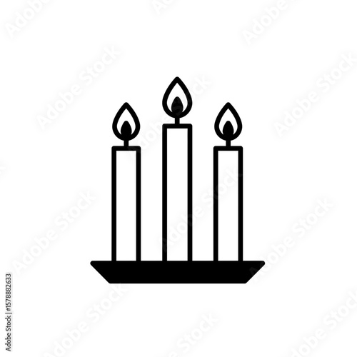 Three burning candles on a candlestick
