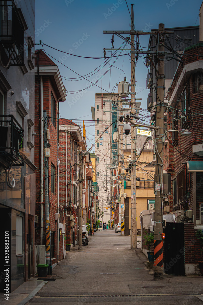 Fototapeta premium Electric pole with tangled power lines in the old town alleyway landscape in Seoul, Republic of Korea
