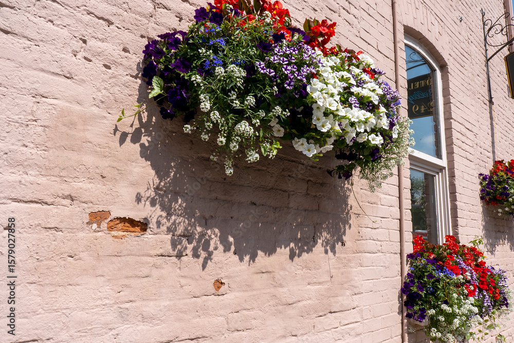 Naklejka premium Window box planters with colorful flowers against building. Old Quebec, Canada.
