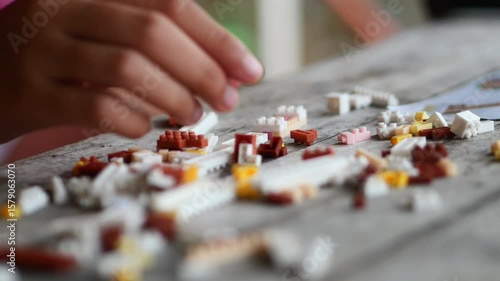 Children hands play with colorful lego blocks 
