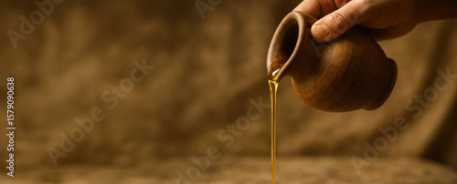Hand Pouring Sacred Oil from a Clay Vessel