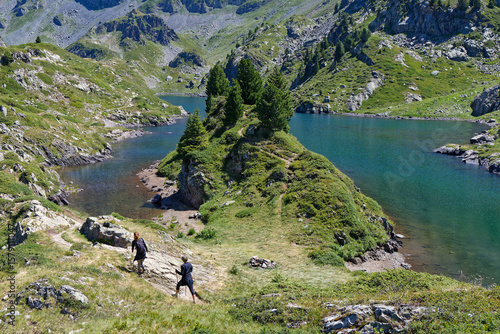 LA PRA, FRANCE, July 10, 2025 : Hiking along the Lac Longet in Belledonne mountain range, on the way to the refuge of La Pra.