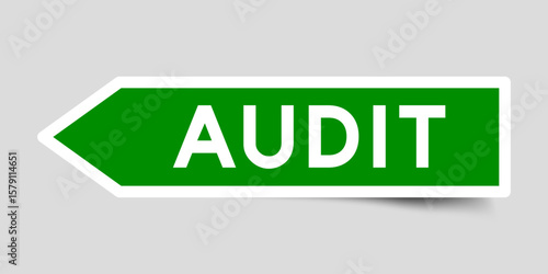 Green color arrow shape sticker label with word audit on gray background