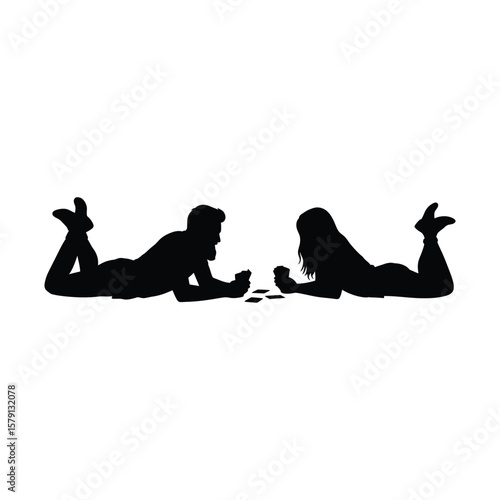 A silhouetted couple is lying down and playing cards together, isolated on white background