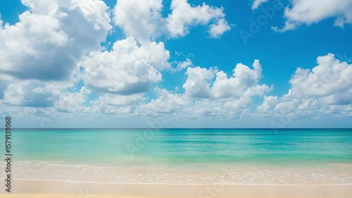 Wallpaper Mural Serene Tropical Beach View with Clear Turquoise Waters and Soft Sandy Shore Under a Bright Blue Sky Filled with Fluffy White Clouds Torontodigital.ca