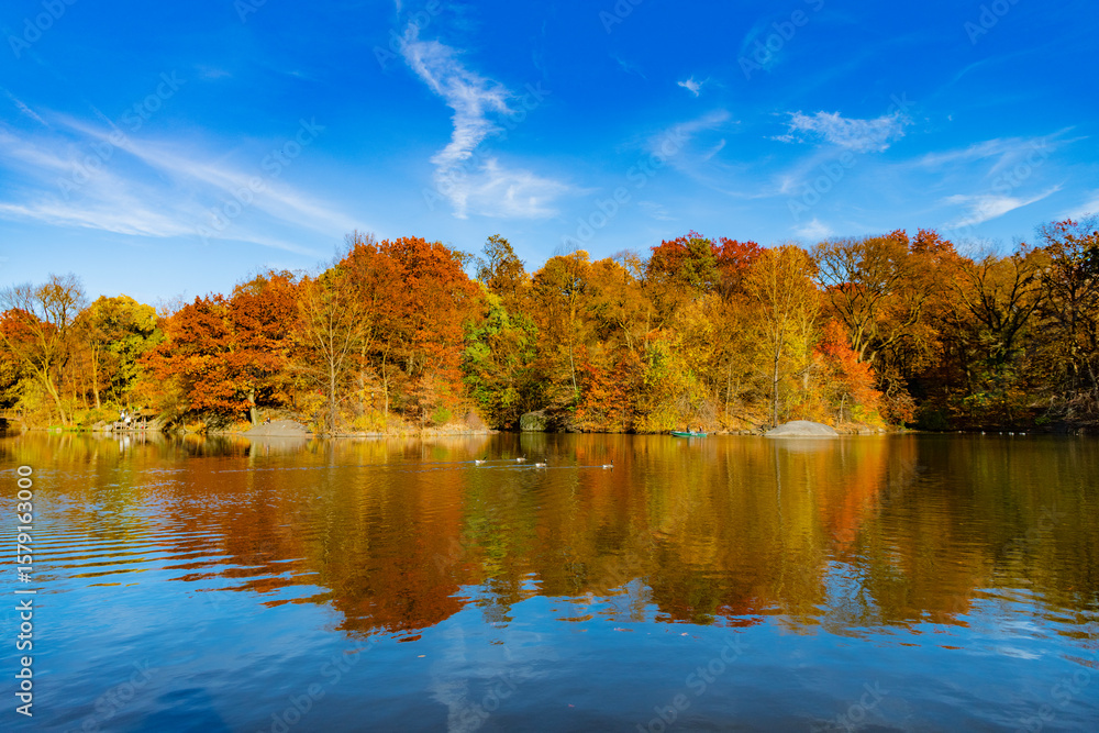 Scenic fall. Central park in autumn. Autumn landscape. Boat in pond. Fall nature landscape. Autumn nature in Central park. Seasonal fall landscape. Park boat in autumn pond, New York. Rent a boat Scenic fall. Central park in autumn. Autumn landscape. Boat in pond. Fall nature landscape. Autumn nature in Central park. Seasonal fall landscape. Park boat in autumn pond, New York. Rent a boat