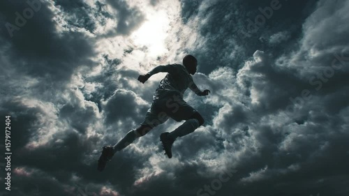 Wallpaper Mural Powerful Leap: Soccer Player Silhouette Against Dramatic Sky Torontodigital.ca