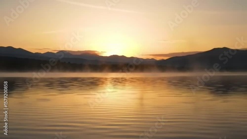 Wallpaper Mural Serene lake at sunrise with mountains in the distance and mist over the water reflecting light Torontodigital.ca