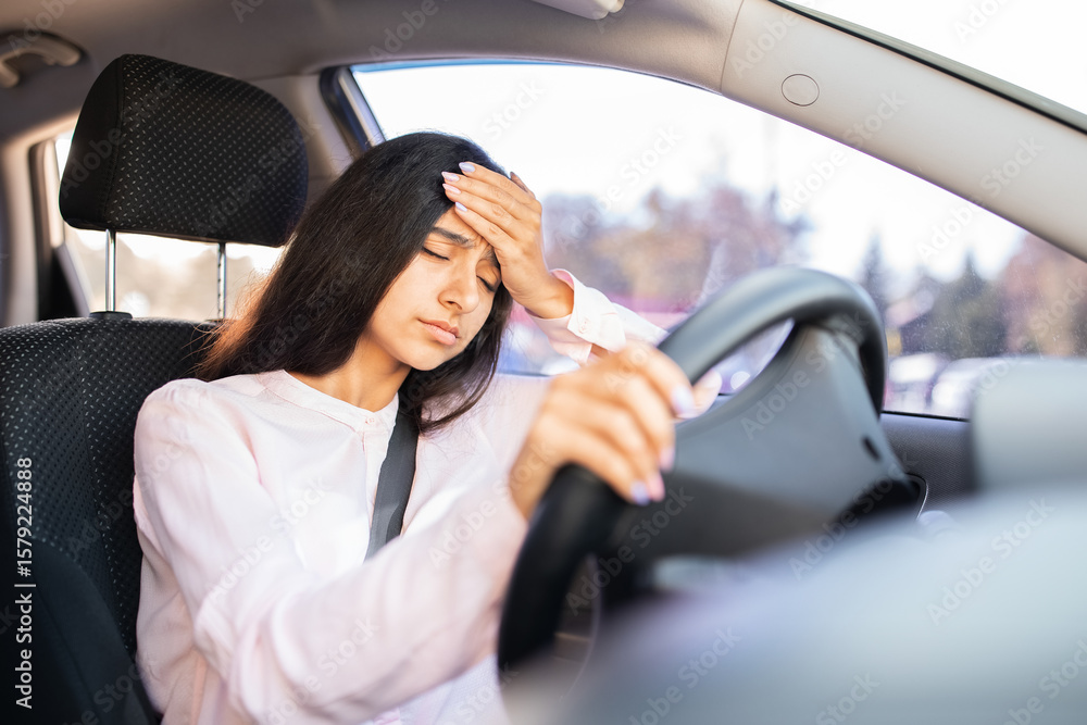 Exhausted Indian woman with hand on forehead inside car, appearing unwell or overwhelmed. Reflects mental fatigue, stress or physical discomfort while driving automobile Exhausted Indian woman with hand on forehead inside car, appearing unwell or overwhelmed. Reflects mental fatigue, stress or physical discomfort while driving automobile