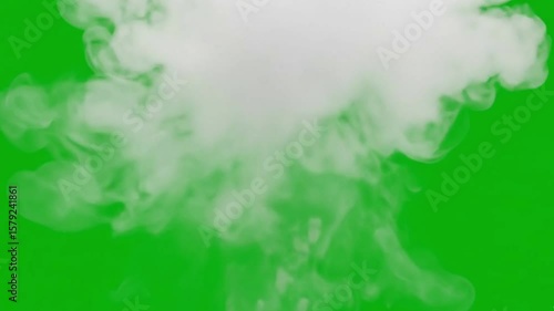 A stock image features a cloud of white smoke rising against a bright green background.