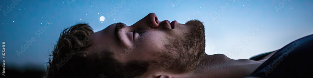 Naklejka premium Man Sleeping Under Night Sky