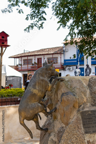 Statue of a dog with park aviary